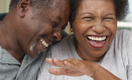A man and woman laughing together.