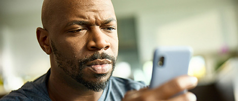 A man scheduling an AHN medical appointment on a cellphone.