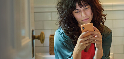 woman using her phone to have a video visit with her doctor