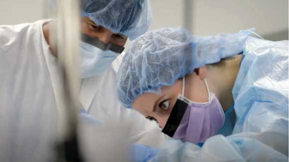 Infectious disease - critical care medicine fellows perform a procedure.