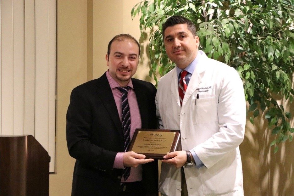ahn Nephrology fellow and doctor holding a plaque
