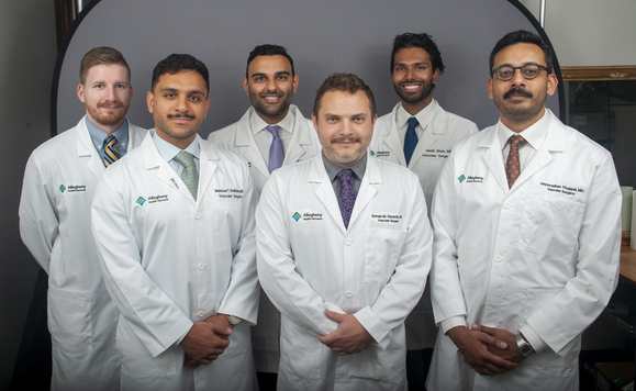 AHN vascular surgery residents standing for photo, wearing white coats