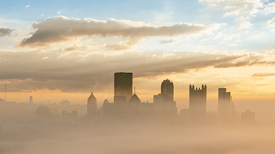 A view of Pittsburgh skyline surrounded by fog.