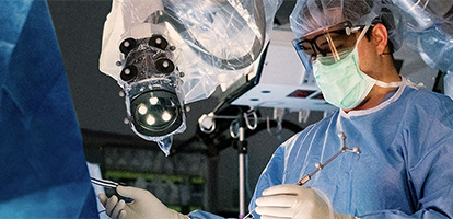 A neuroscience surgeon focusing on procedure during a surgery.