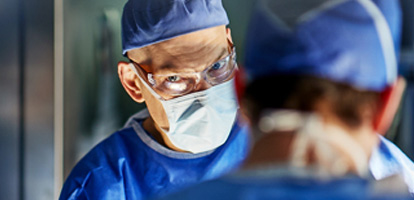 AHN Surgeon looking at the camera while performing surgery.