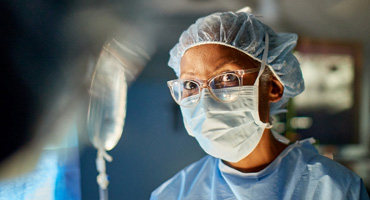 AHN surgeon looking to his fellow staff while in surgery.